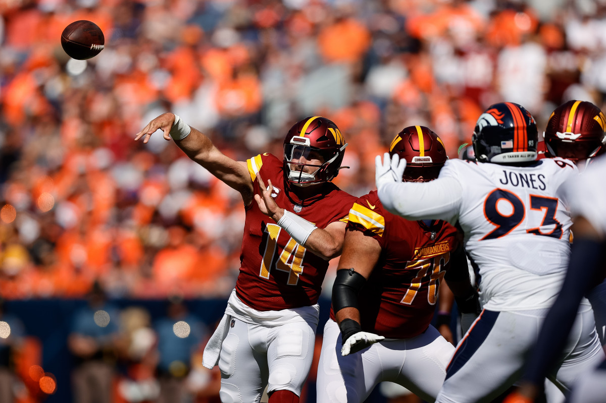 Sep 17, 2023; Denver, Colorado, USA; Washington Commanders quarterback Sam Howell (14) attempts a pass as offensive tackle Sam Cosmi (76) defends against Denver Broncos defensive tackle D.J. Jones (93) in the first quarter at Empower Field at Mile High. Mandatory Credit: Isaiah J. Downing-USA TODAY Sports